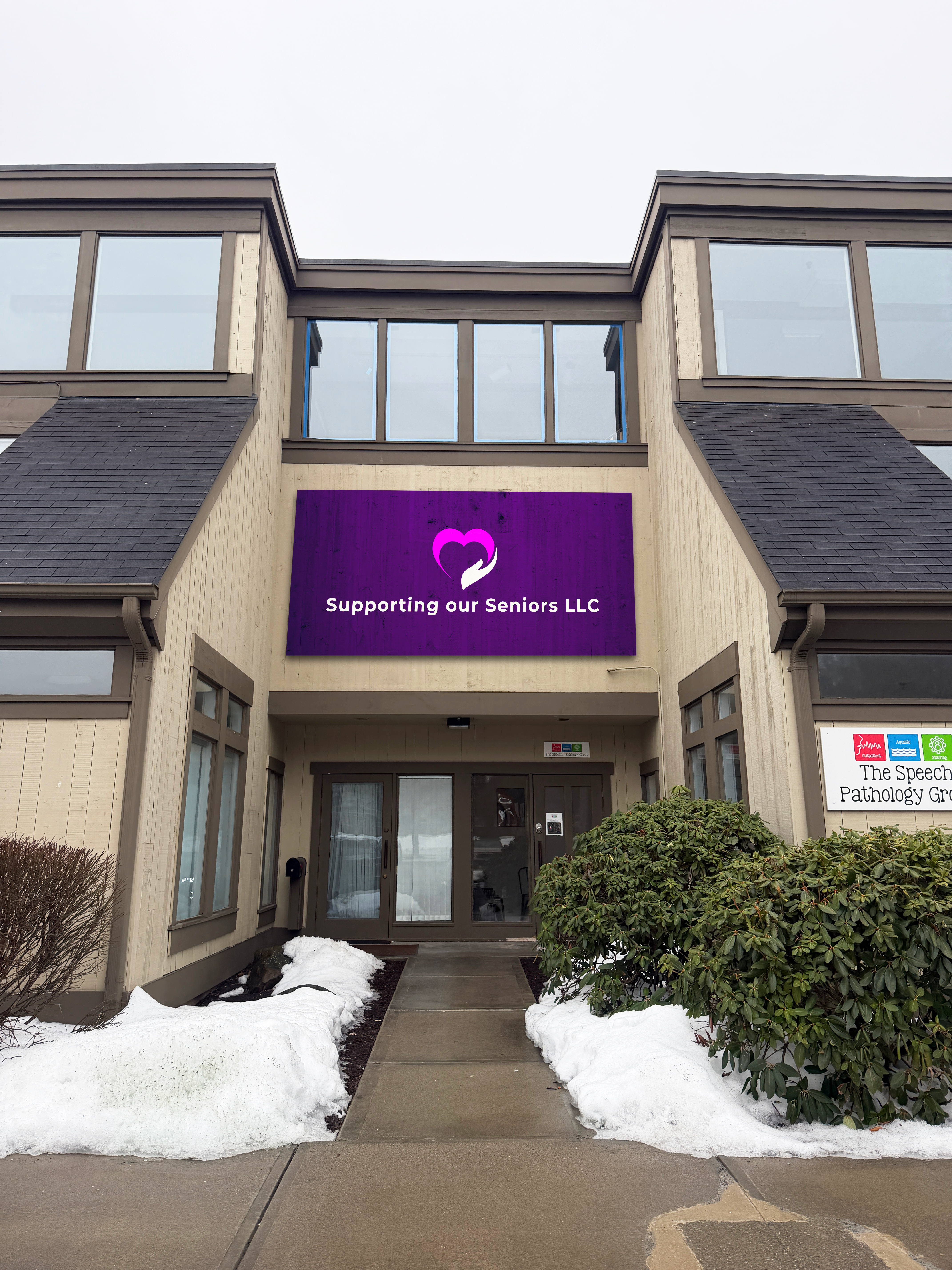 Picture of the Office with a Sign above the front doors, with our logo