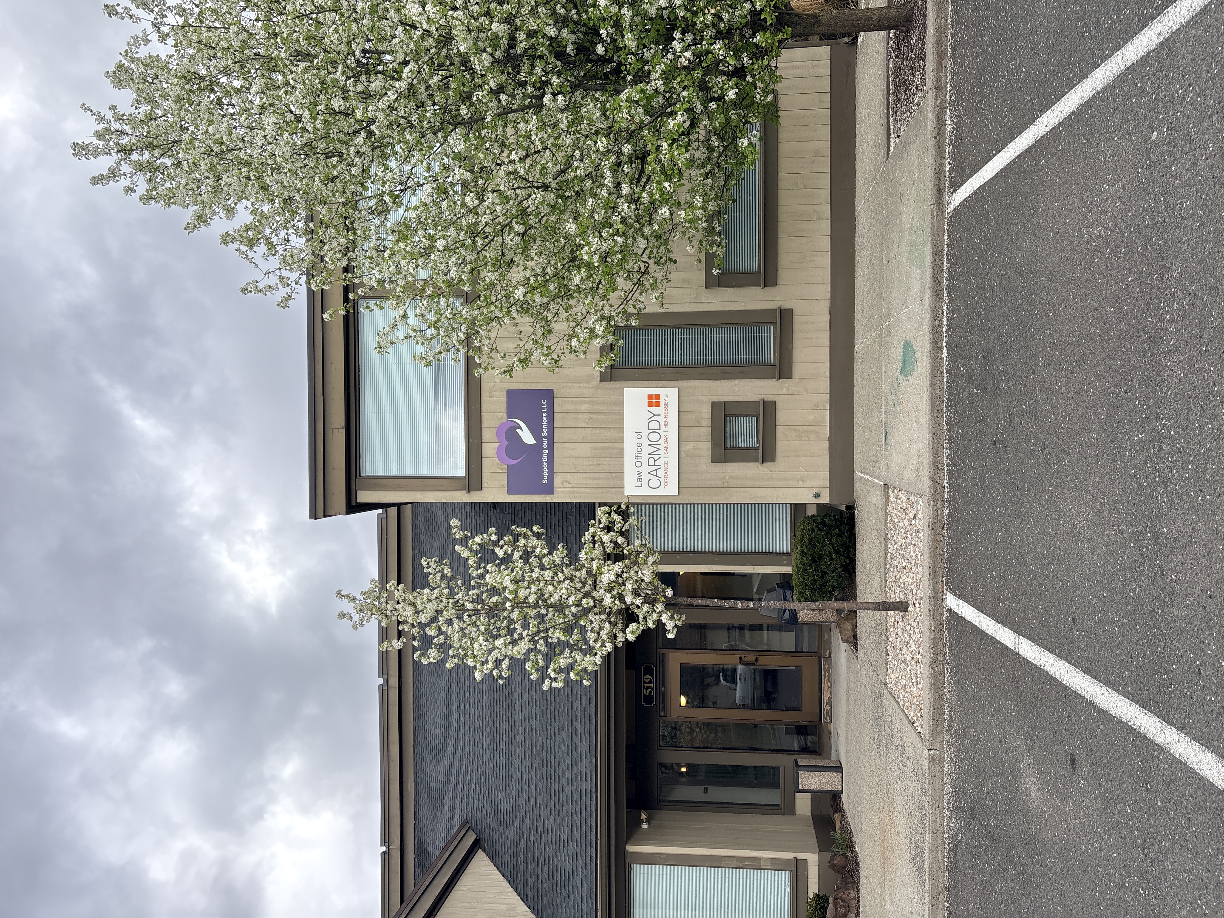 Picture of the Office with a Sign above the front doors, with our logo